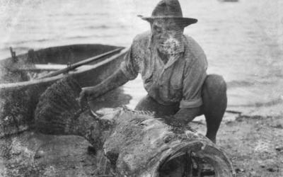 Man displays a fish caught while at the Yule Island base, 1944.