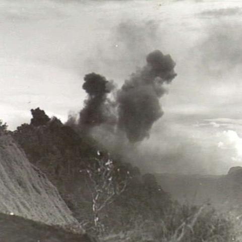 SHAGGY RIDGE, NEW GUINEA. 1943-12-27. 500 POUNDER BOMBS DROPPED FROM UNITED STATES ARMY FIGHTER AIRCRAFT EXPLODING ON JAPANESE POSITIONS ON THE "PIMPLE" DURING THE 2/16TH AUSTRALIAN INFANTRY BATTALION, 21ST AUSTRALIAN INFANTRY BRIGADE ASSAULT ON THE RIDGE.