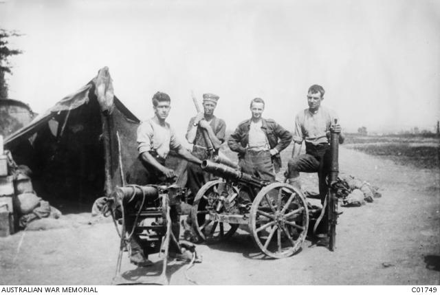 Four unidentified gunners pose with some German weapons 