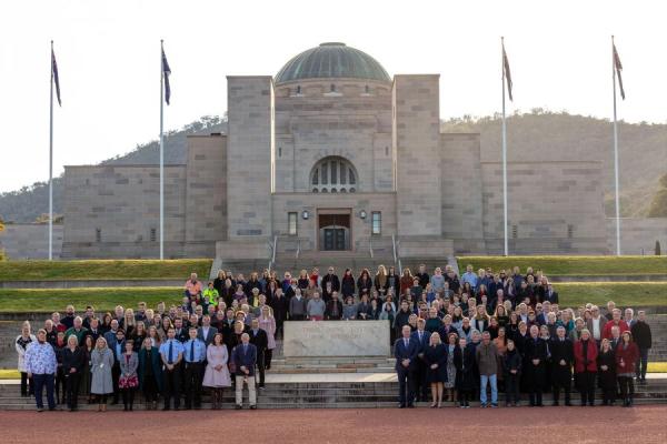 Photo of AWM staff standing on the Parade Group at the Southern Entrance of the Memorial