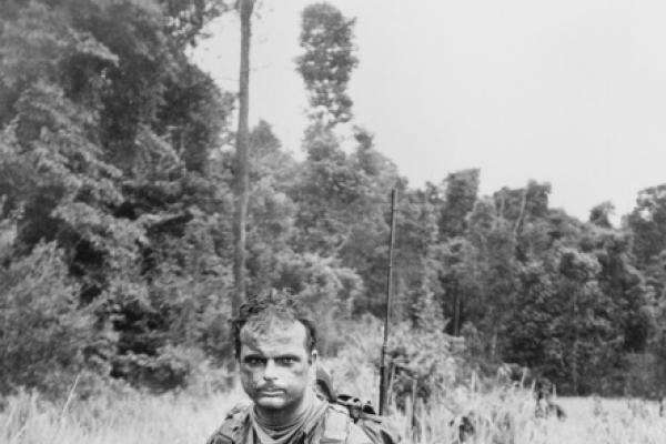 Patrolling through kunai grass, South Vietnam, 1971