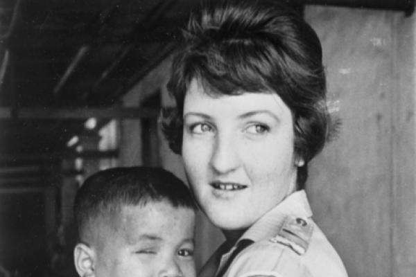 Australian Red Cross nurse Carol Eacott with a Vietnamese orphan, January 1970
