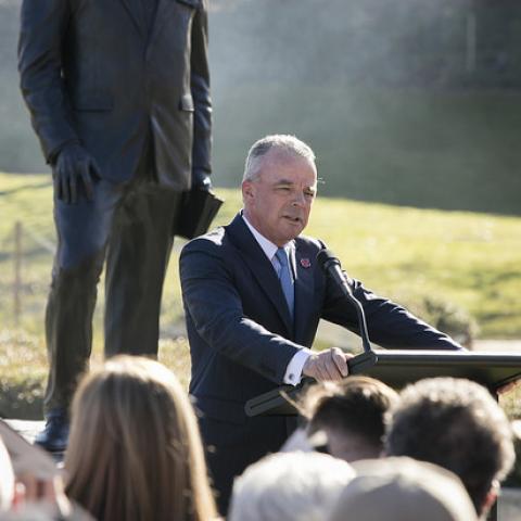 Dr Brendan Nelson speaking in front of Sir John Monash sculpture