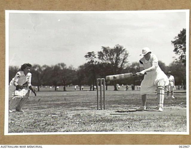 Kathleen playing cricket, 1944. A L Fraser, AWM 062967