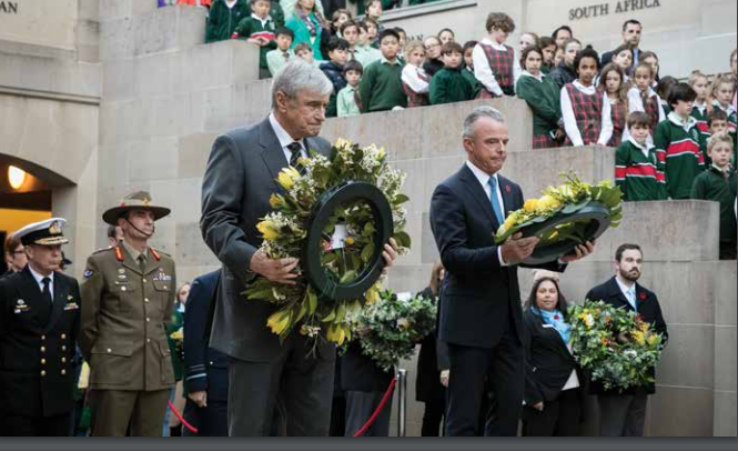 Chairman and Director laying wreaths