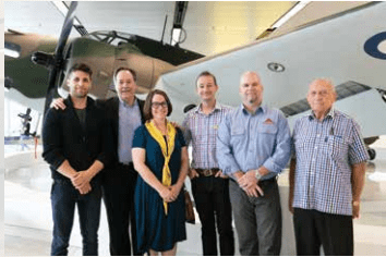 Hudson aircraft with the conservators who worked on it