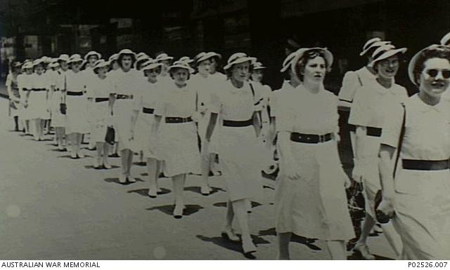 A group of Voluntary Aid Detachment (VAD) nurses marching along George Street after attending a Christmas service (P02526.007)