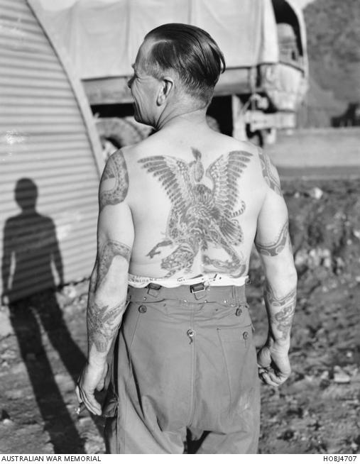 William Seraphina, of 2RAR, 1950. Each tattoo represents a place he's been, over decades of service.